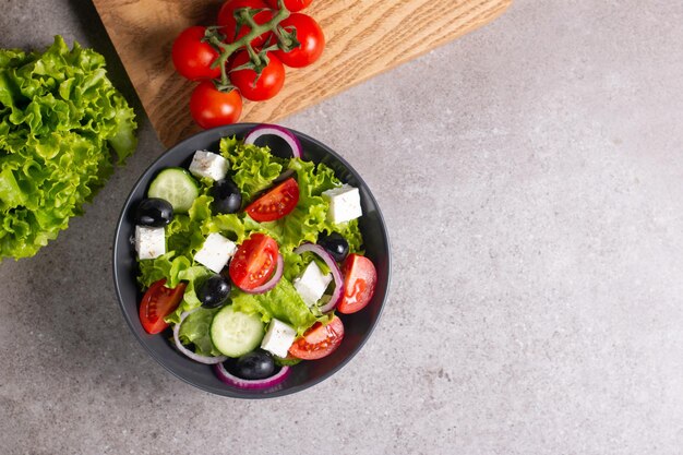 Greek salad with fresh tomatoes, cucumber, olives, feta cheese and red onion. Healthy and diet food