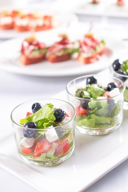 Greek salad with fresh vegetables in a glass