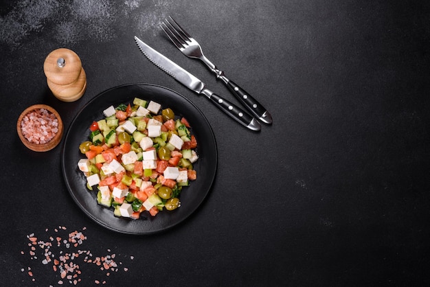 Greek salad with juicy tomatoes feta cheese lettuce green olives cucumber red onion and fresh parsley