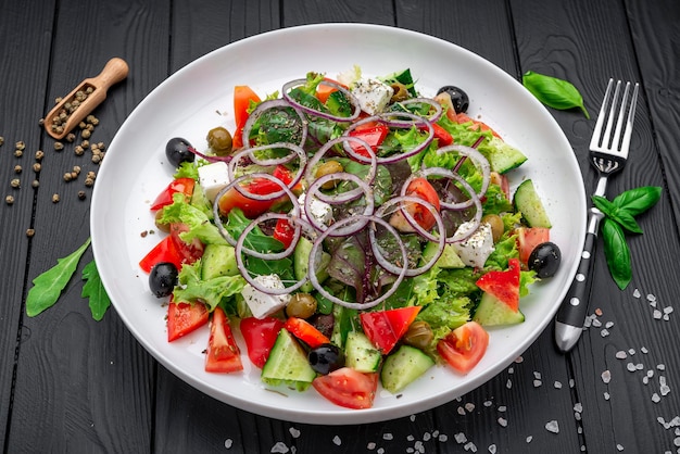 Greek salad with olive oil fresh vegetables olives and fetta cheese