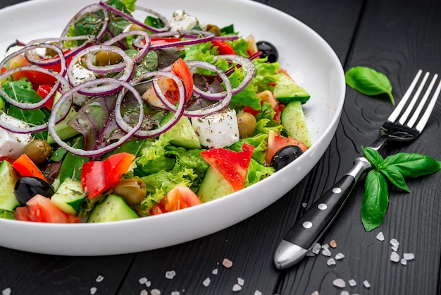 Greek salad with olive oil fresh vegetables olives and fetta cheese