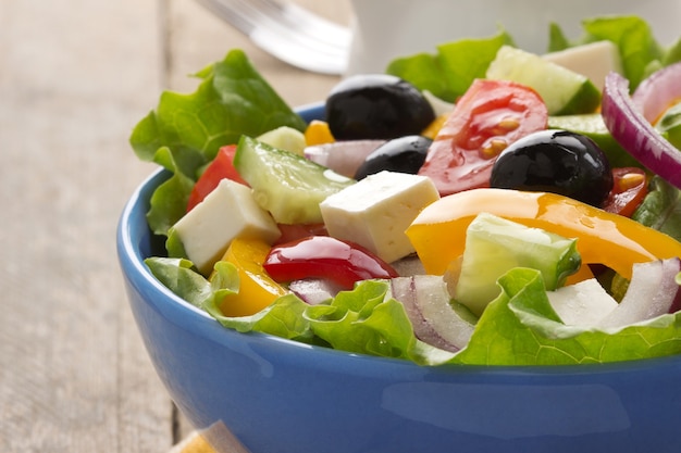 Greek salad on wood background