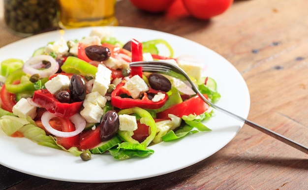 Greek salad on wooden background