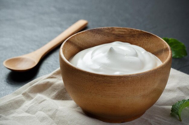 Greek yogurt on black stone background