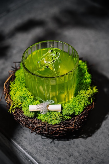 A green alcoholic drink in a clear glass