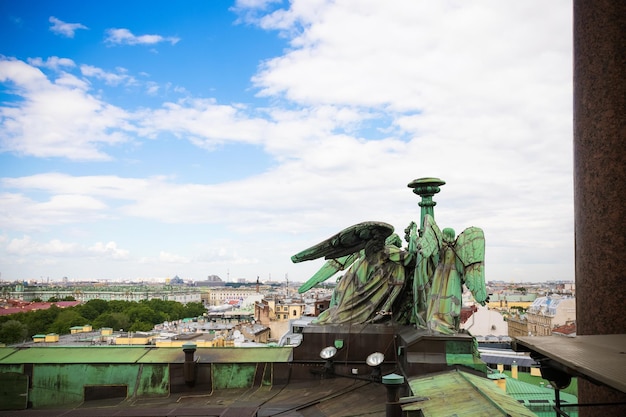 Green angels on roof of St Isaac's Cathedral and city view St Petersburg Russia June 2022