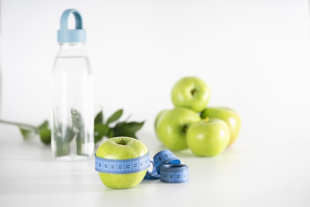 Green apple as a symbol of healthy and sports nutrition and weight loss.