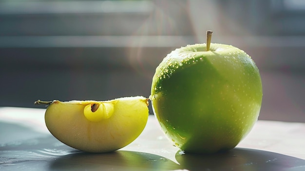 a green apple and a half of a green apple are next to a green apple