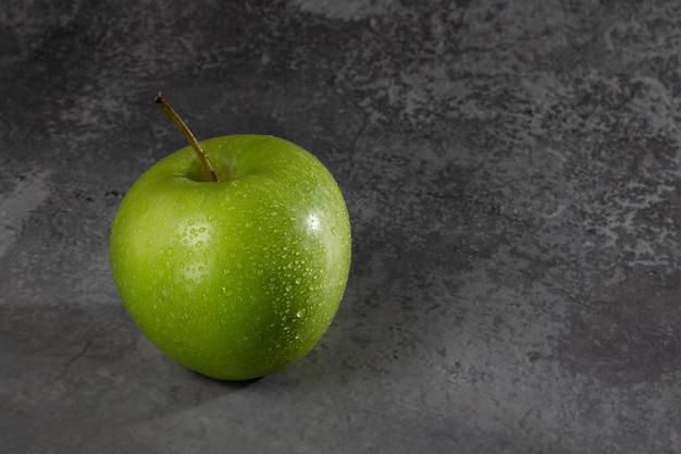 Green apple with water drops