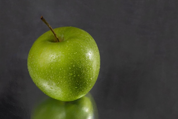 Green apple with water drops