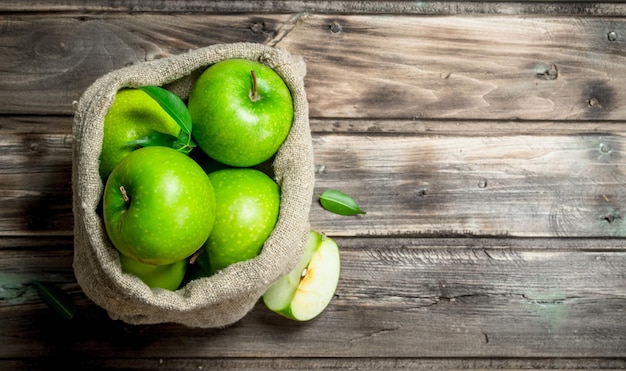 Green apples and Apple slices in an old bag