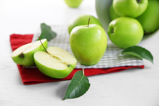 Green apples on table with napkins closeup