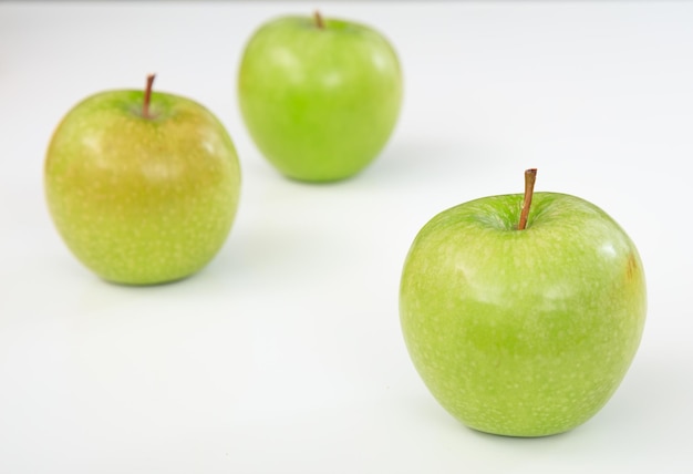 Green apples on white background