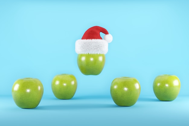 Green Apples with Santa Hat floating on blue