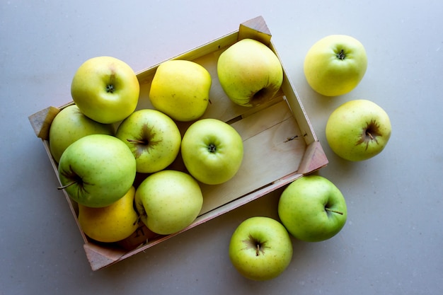 Green apples in a wooden crate