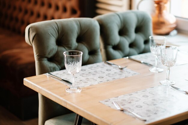 Green armchair in an empty cafe during pandemic No guests Served table