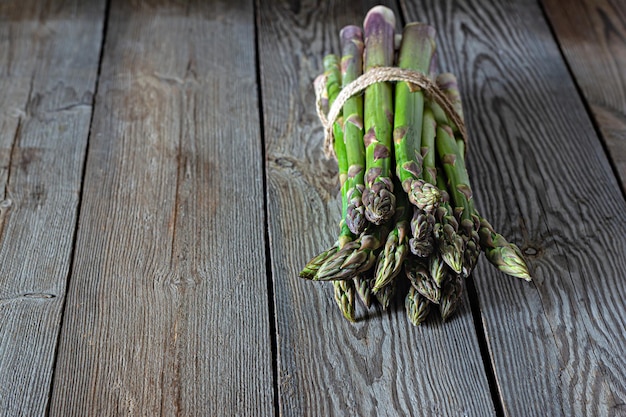 Green asparagus on a dark wooden background Raw food concept place for copy space