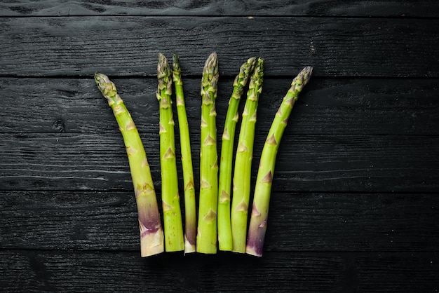 Green asparagus Fresh asparagus on a black background Top view Free space for your text