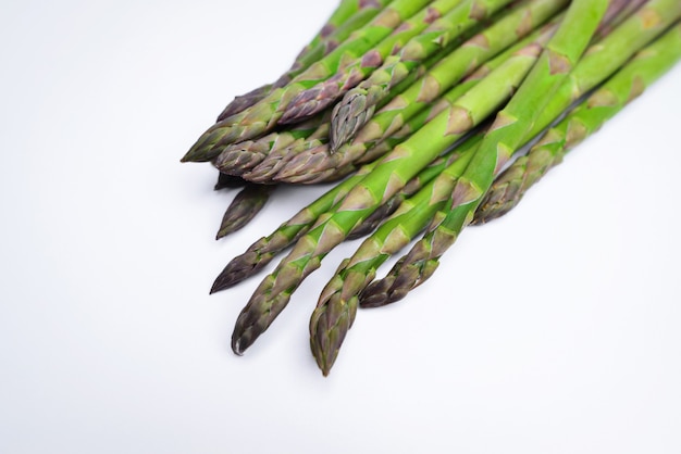 Green asparagus sticks isolated on white background Studio shot Vegetables Asparagus Isolated on White Background Fresh ripe asparagus on a white background