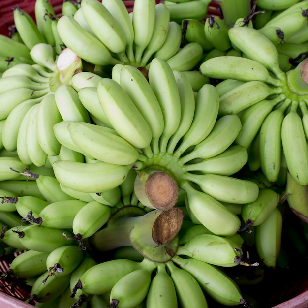 Green banana bundle in basket ready to sell