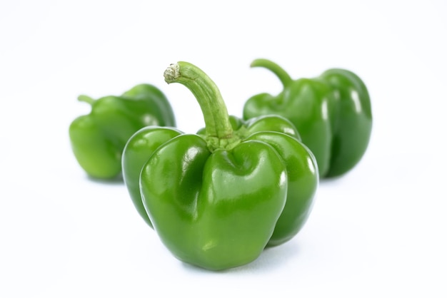 Green bell peppers on a white background