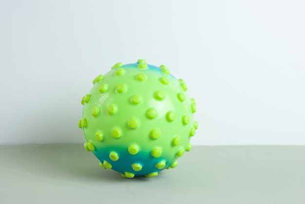 A green and blue ball with the word " ball " on it.