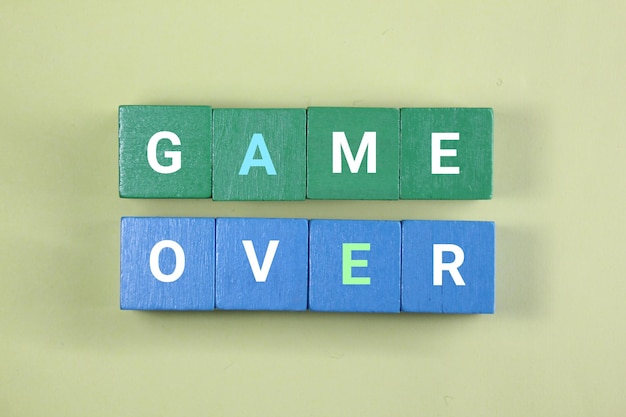 A green and blue blocks with the word game over on them.