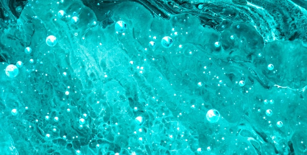 Photo a green and blue liquid with bubbles in the water