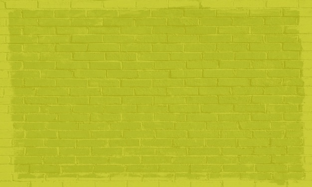 A green brick wall with a yellow paint stain.