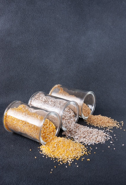 Green buckwheat corn millet groats in glass jars