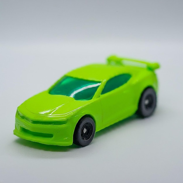 a green car with a black tire and a black rim