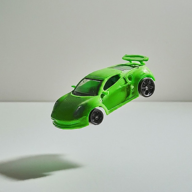 a green car with a green roof is on a white table