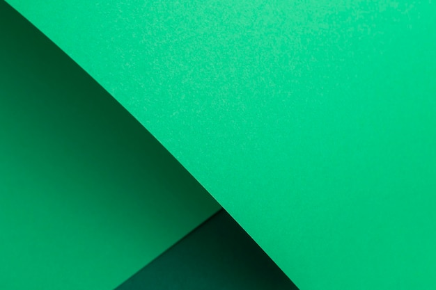 Green cardboard background design folded geometrically. Top view, flat lay.