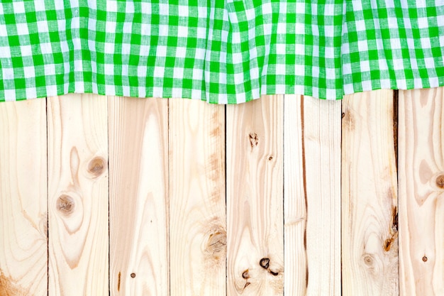 Green checkered tablecloth on wooden table