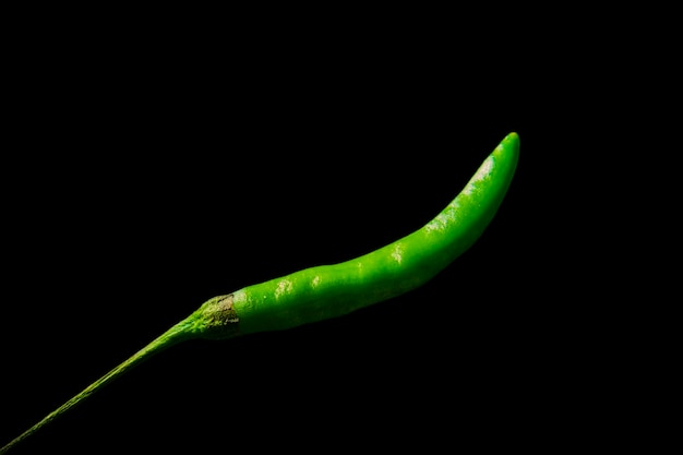 Green chili hot and fresh isolated on black background studio photography