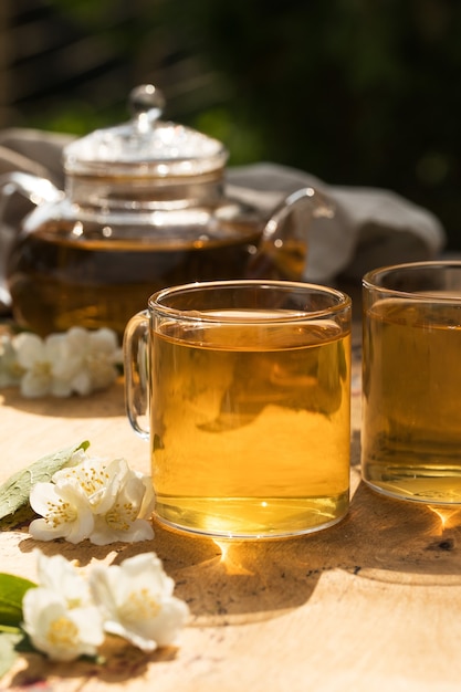 Green chinese tea with jasmine in a mug with jasmine flowers