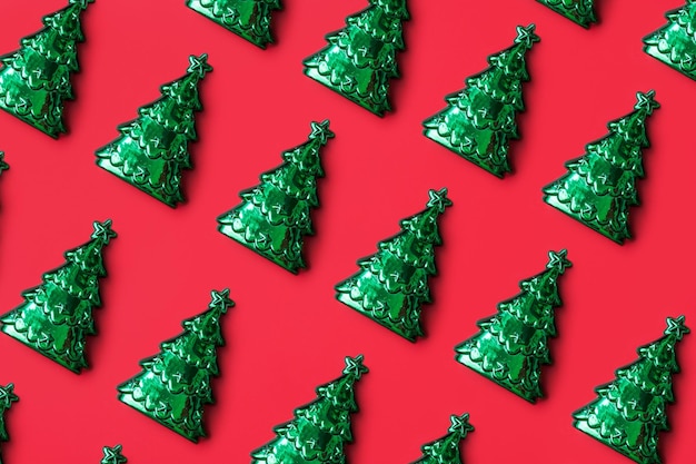 Green Christmas tree pattern minimal flatlay on red background new year holiday celebration concept