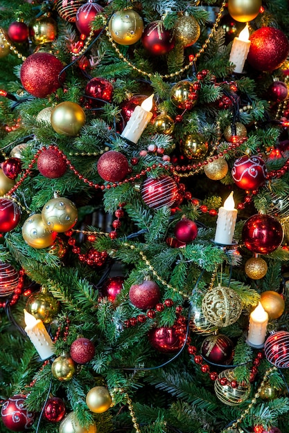 Green Classic christmas tree decorated with christmas balls and candles