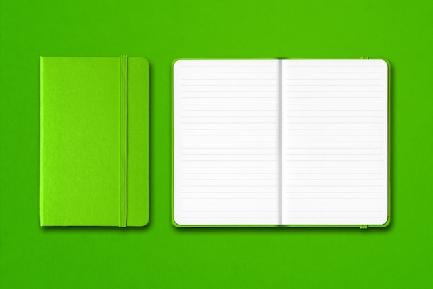 Green closed and open lined notebooks isolated