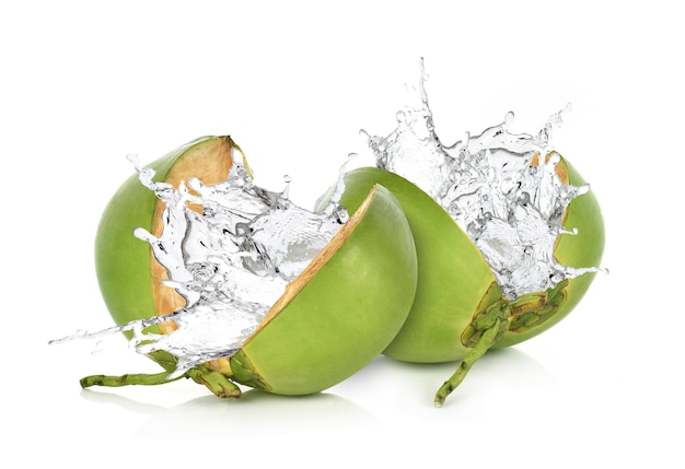 Green coconut with water splash isolated on white background.