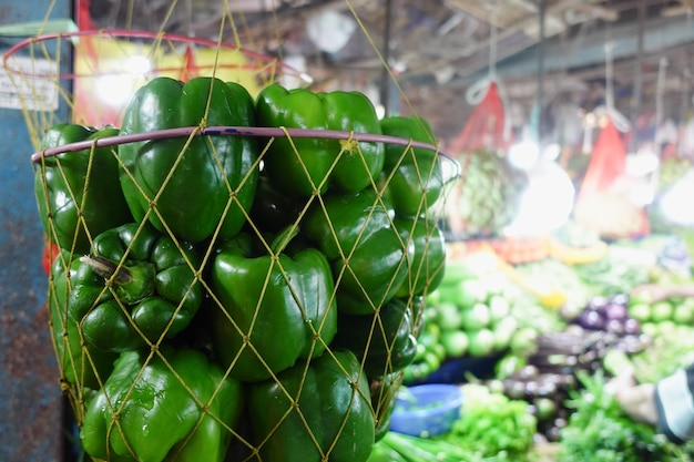 Green color capsicum display for sale at local store