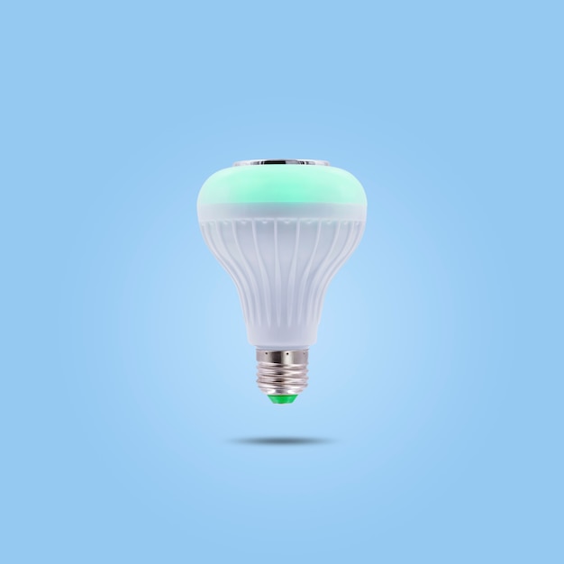 Green color LED energy saving lamp 230v isolated on blue pastel color background.