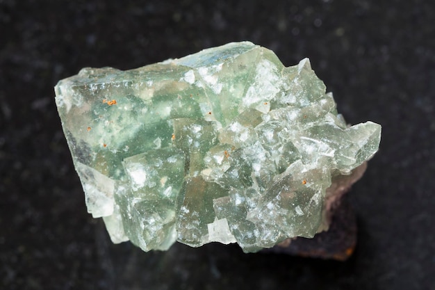 Green crystalline fluorite gemstone on dark