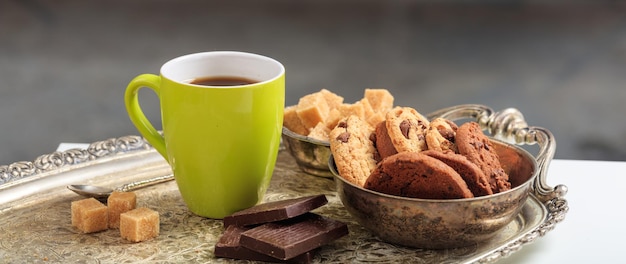 A green cup of coffee on an old tray