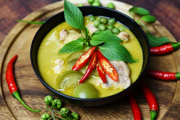 green curry chicken in a black bowl