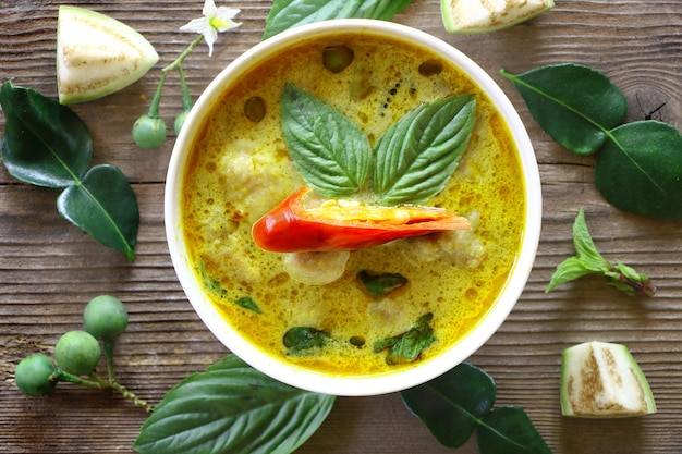 green curry fish ball in white plate on wood table