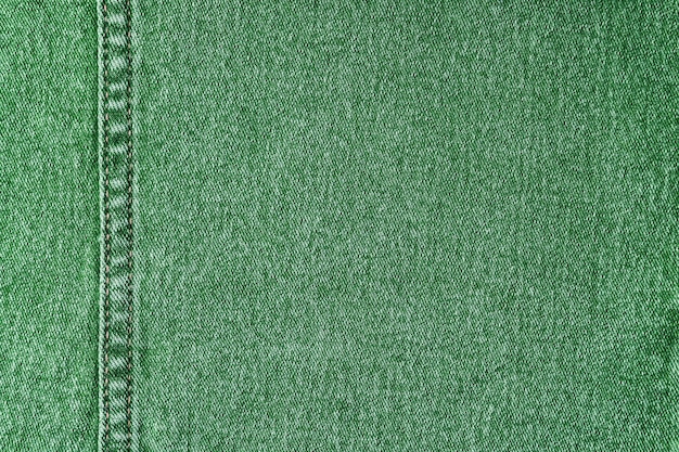 Green denim jeans with a seam texture background