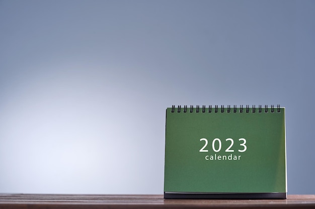 Green desk 2023 calendar against gray background