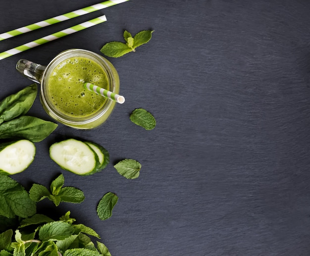 Green detox smoothie in a glass jar top view