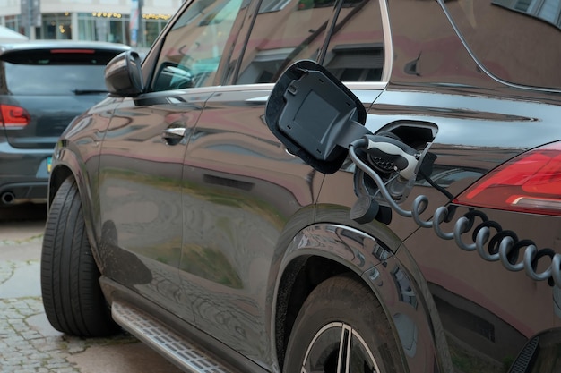 Green energy concept electric car stands at the charging station